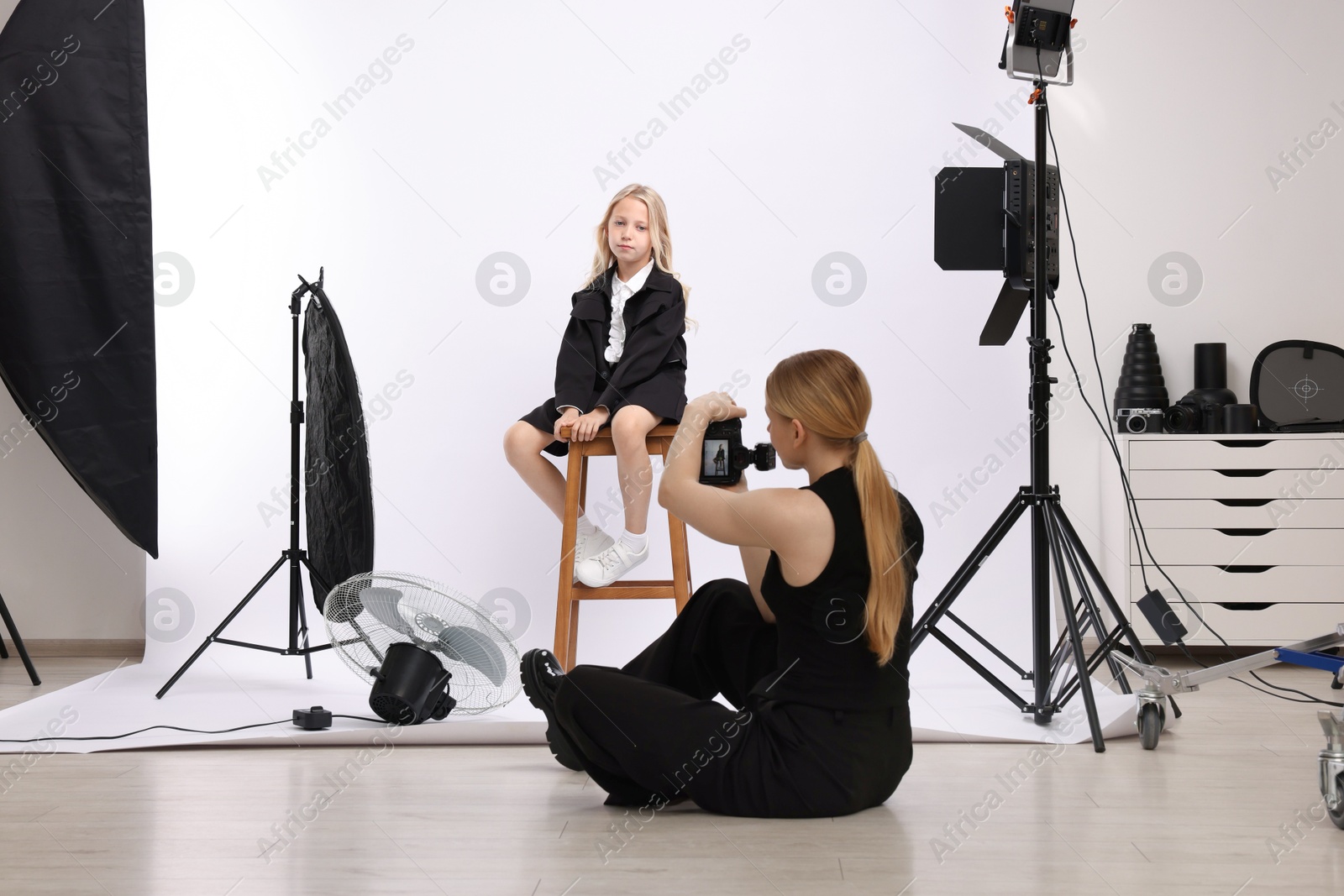 Photo of Photographer working with model in professional photo studio