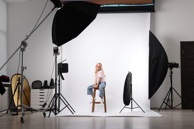 Photo of Little girl on white background in photo studio with professional equipment