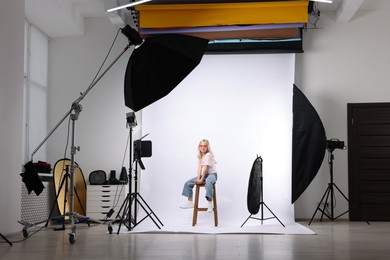Photo of Little girl on white background in photo studio with professional equipment