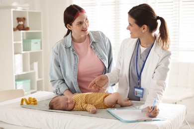 Photo of Mother and her cute baby having appointment with pediatrician in hospital