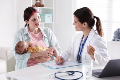 Photo of Mother and her cute baby having appointment with pediatrician in hospital