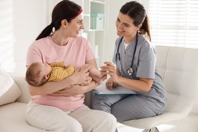 Photo of Mother and her cute baby having appointment with pediatrician in hospital