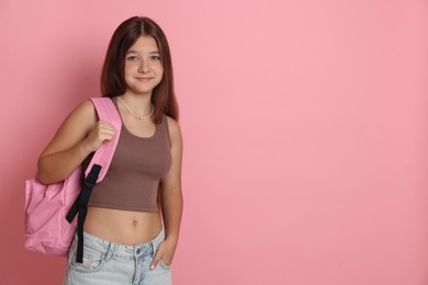 Photo of Teenage girl with backpack on pink background, space for text