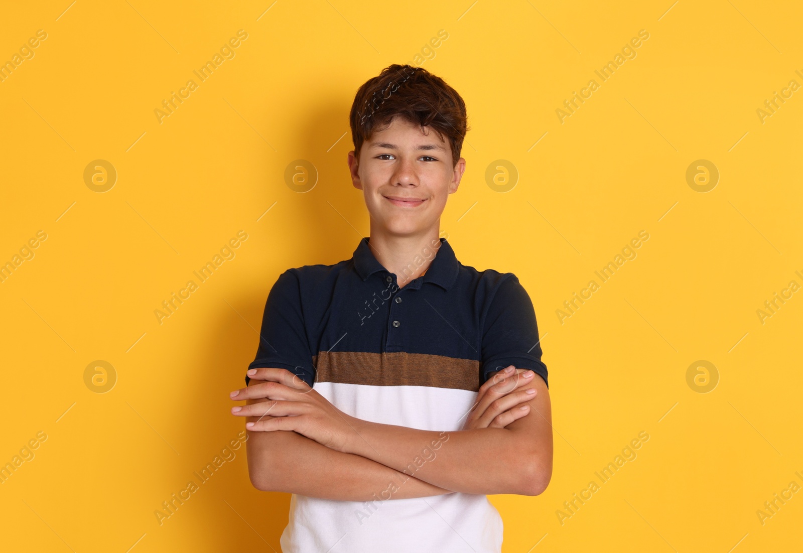 Portrait of teenage boy on orange background Photo of Portrait of teenage boy on orange background