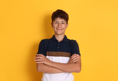 Photo of Portrait of teenage boy on orange background