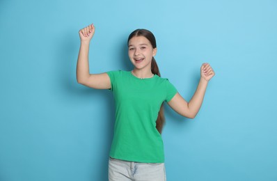 Photo of Portrait of teenage girl on light blue background