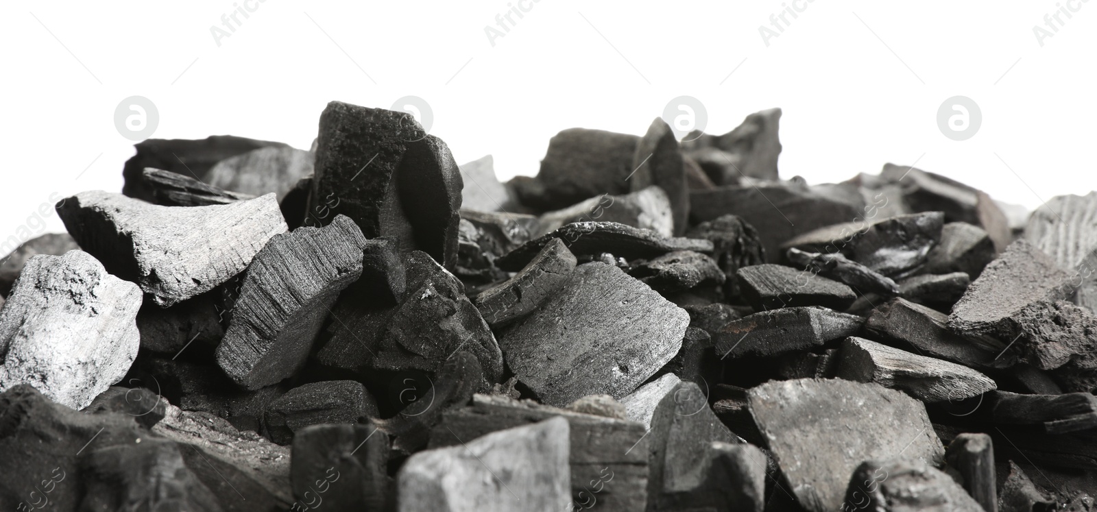 Pieces of black coals on white background Photo of Pieces of black coals on white background