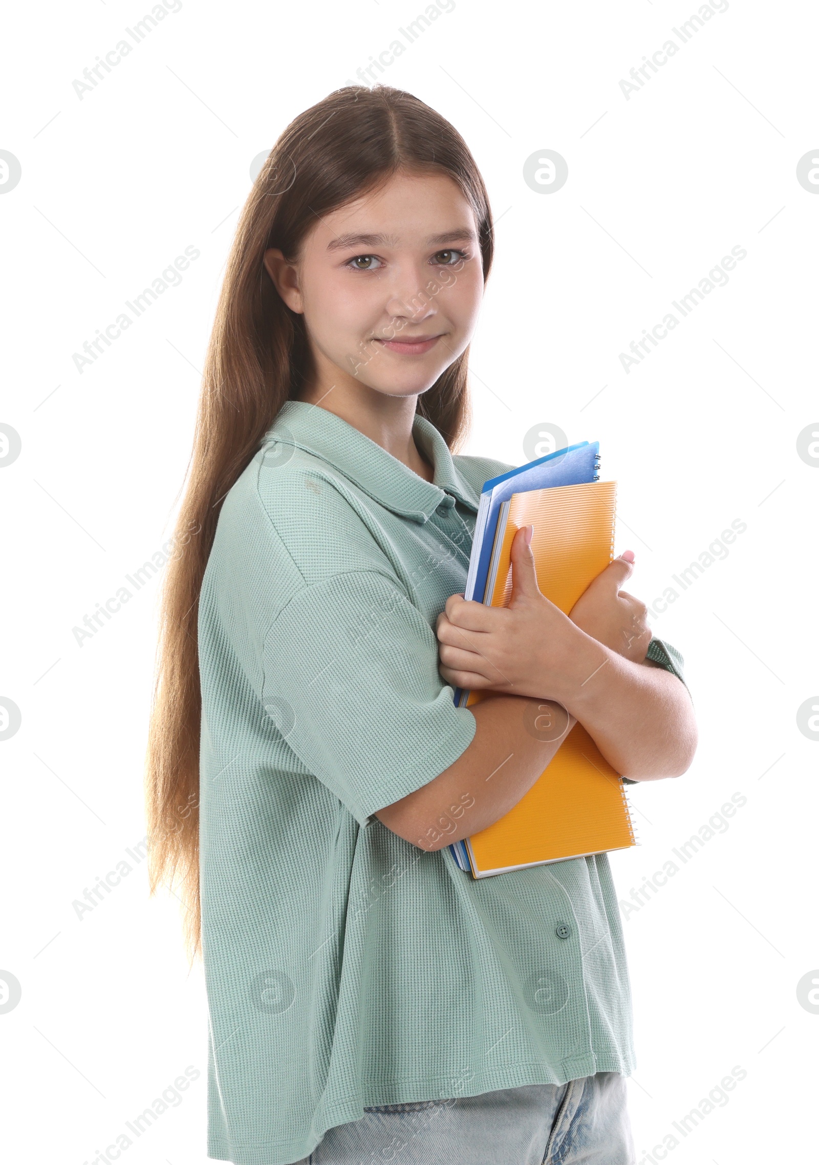 Teenage girl with notebooks on white background Photo of Teenage girl with notebooks on white background