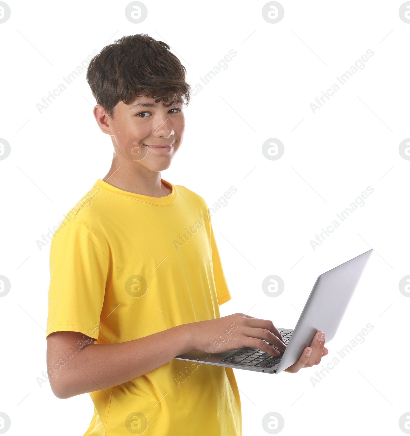 Teenage boy with laptop on white background Photo of Teenage boy with laptop on white background