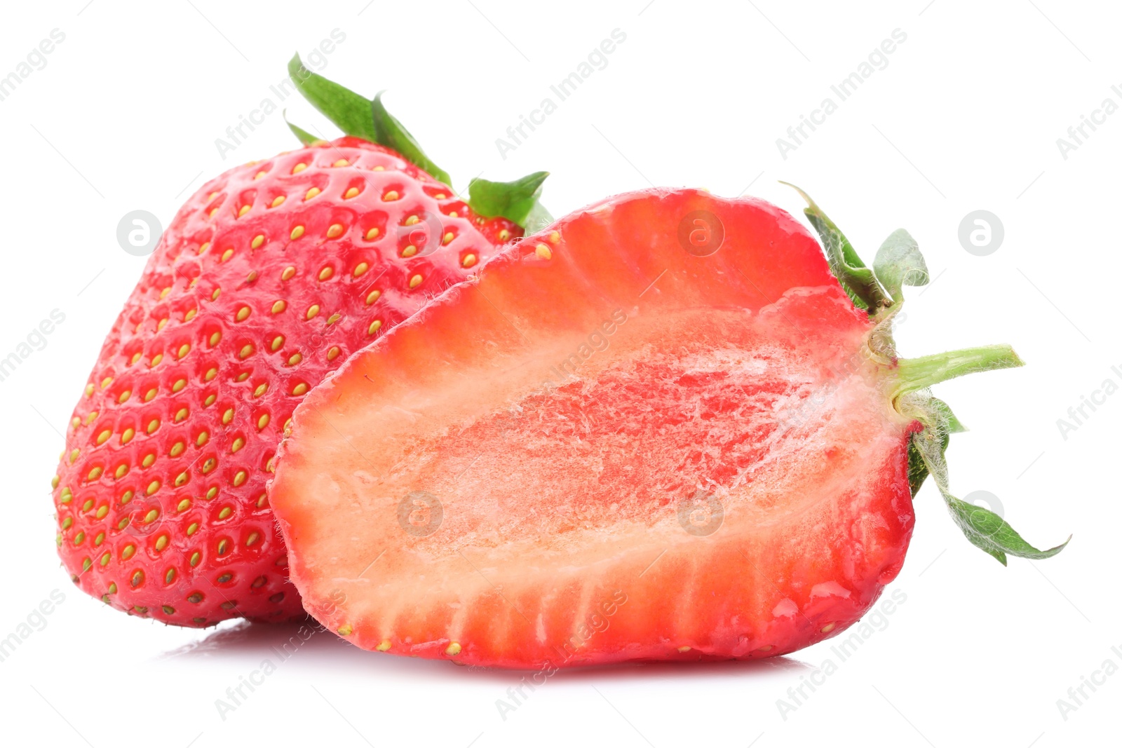 Whole and half of fresh strawberries isolated on white Photo of Whole and half of fresh strawberries isolated on white