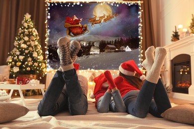 Image of Family watching Christmas movie using video projector at home