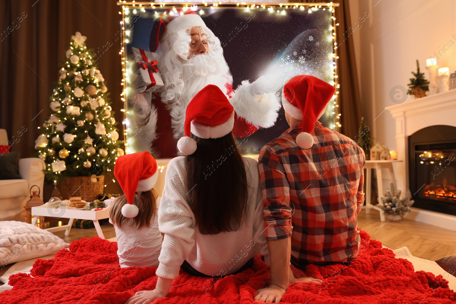 Family watching Christmas movie using video projector at home Image of Family watching Christmas movie using video projector at home