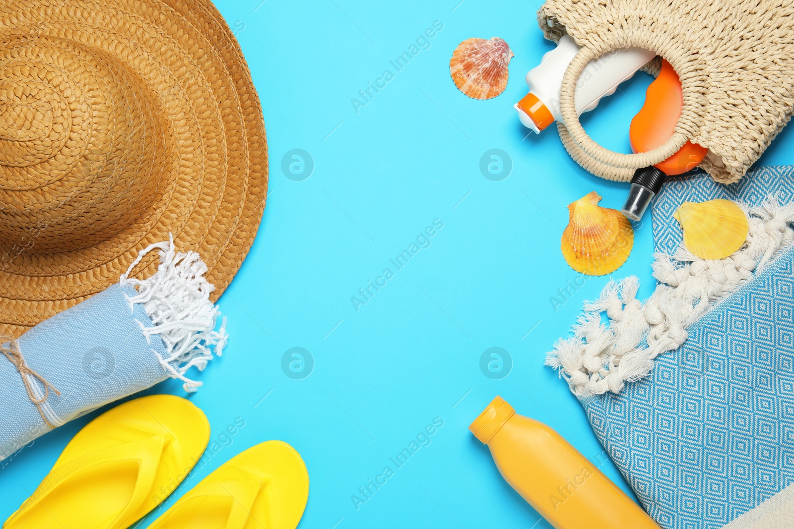 Flat lay composition with beach towel and other summer accessories on light blue background. Space for text Photo of Flat lay composition with beach towel and other summer accessories on light blue background. Space for text