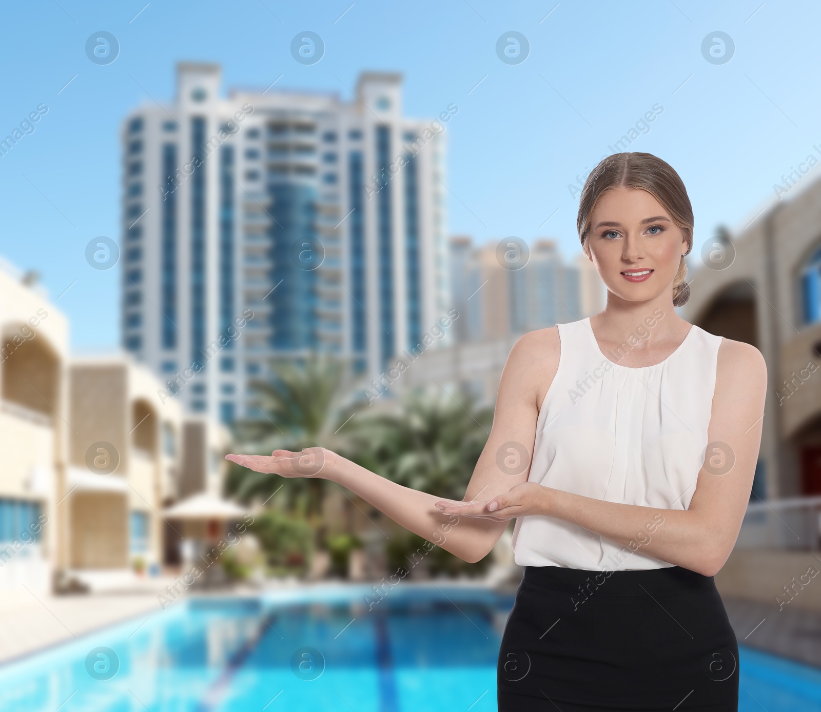 Image of Young hostess in uniform welcoming to sea resort