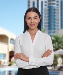 Image of Young hostess in uniform at sea resort