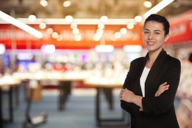 Image of Young hostess in uniform at shopping mall