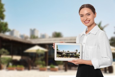 Image of Young hostess with tablet computer presenting sea resort