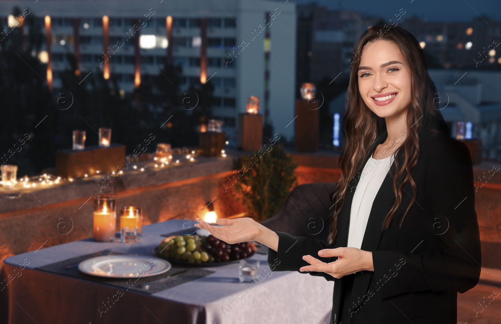 Young hostess welcoming to served table at roof restaurant Image of Young hostess welcoming to served table at roof restaurant