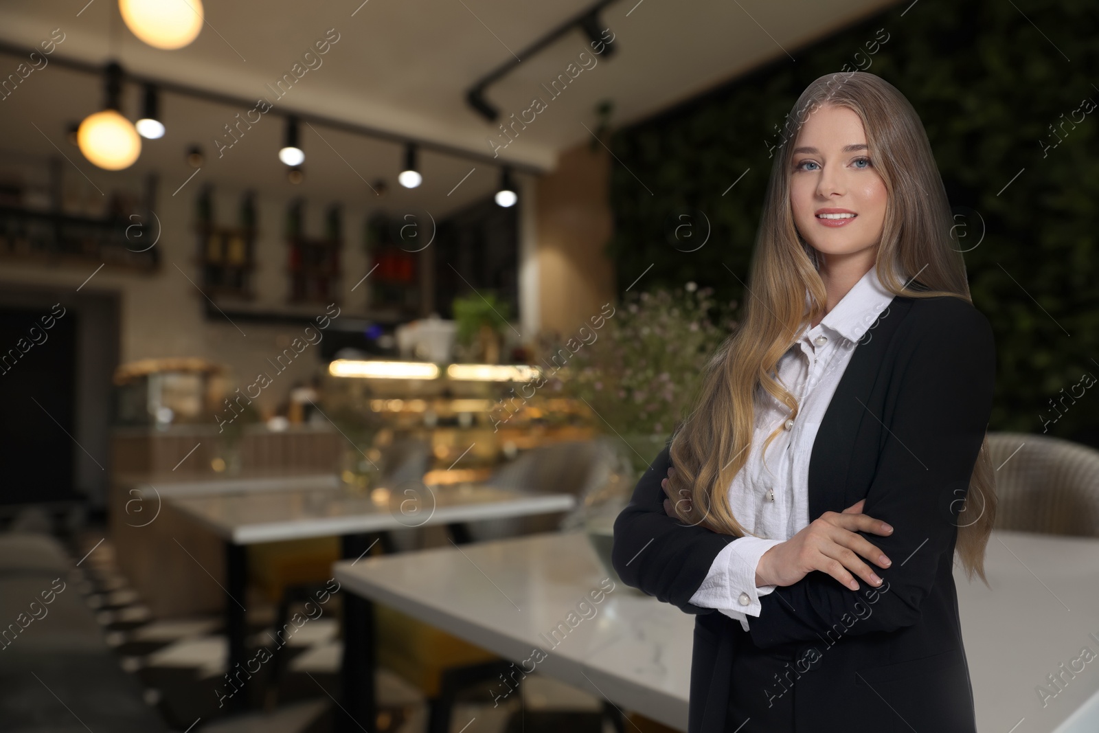 Young smiling hostess wearing uniform in restaurant Image of Young smiling hostess wearing uniform in restaurant