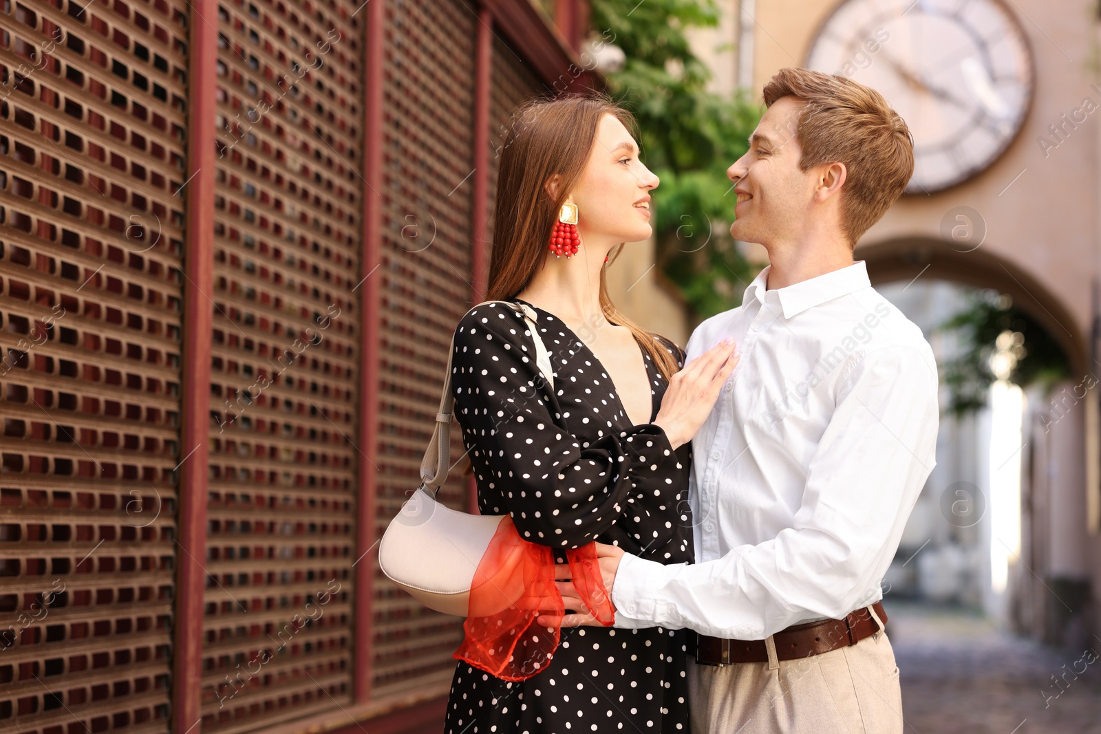 Lovely couple walking together on city street Photo of Lovely couple walking together on city street