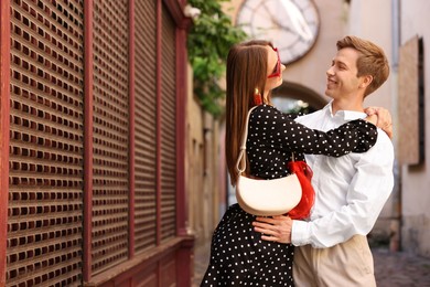 Photo of Lovely couple walking together on city street