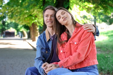 Photo of Lovely couple spending time together in park, space for text