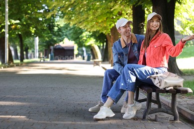 Photo of Lovely couple spending time together in park, space for text