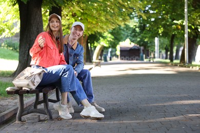 Photo of Lovely couple spending time together in park, space for text