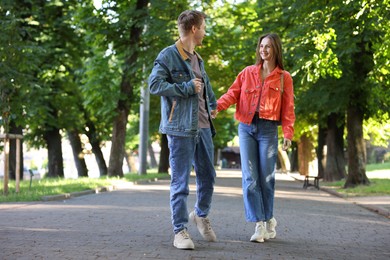 Photo of Lovely couple walking together in park, space for text