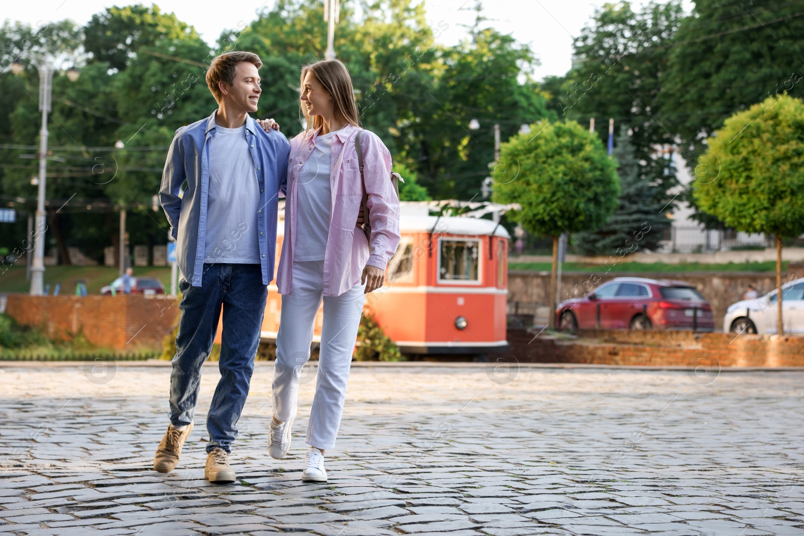 Lovely couple walking together on city street, space for text Photo of Lovely couple walking together on city street, space for text