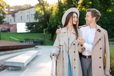 Photo of Lovely couple walking together on city street, space for text