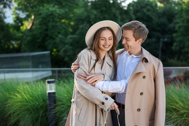 Photo of Lovely couple walking together on city street, space for text