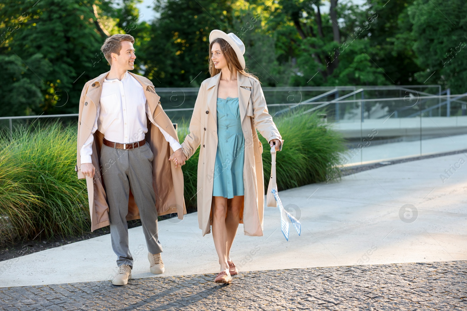 Lovely couple walking together on city street, space for text Photo of Lovely couple walking together on city street, space for text