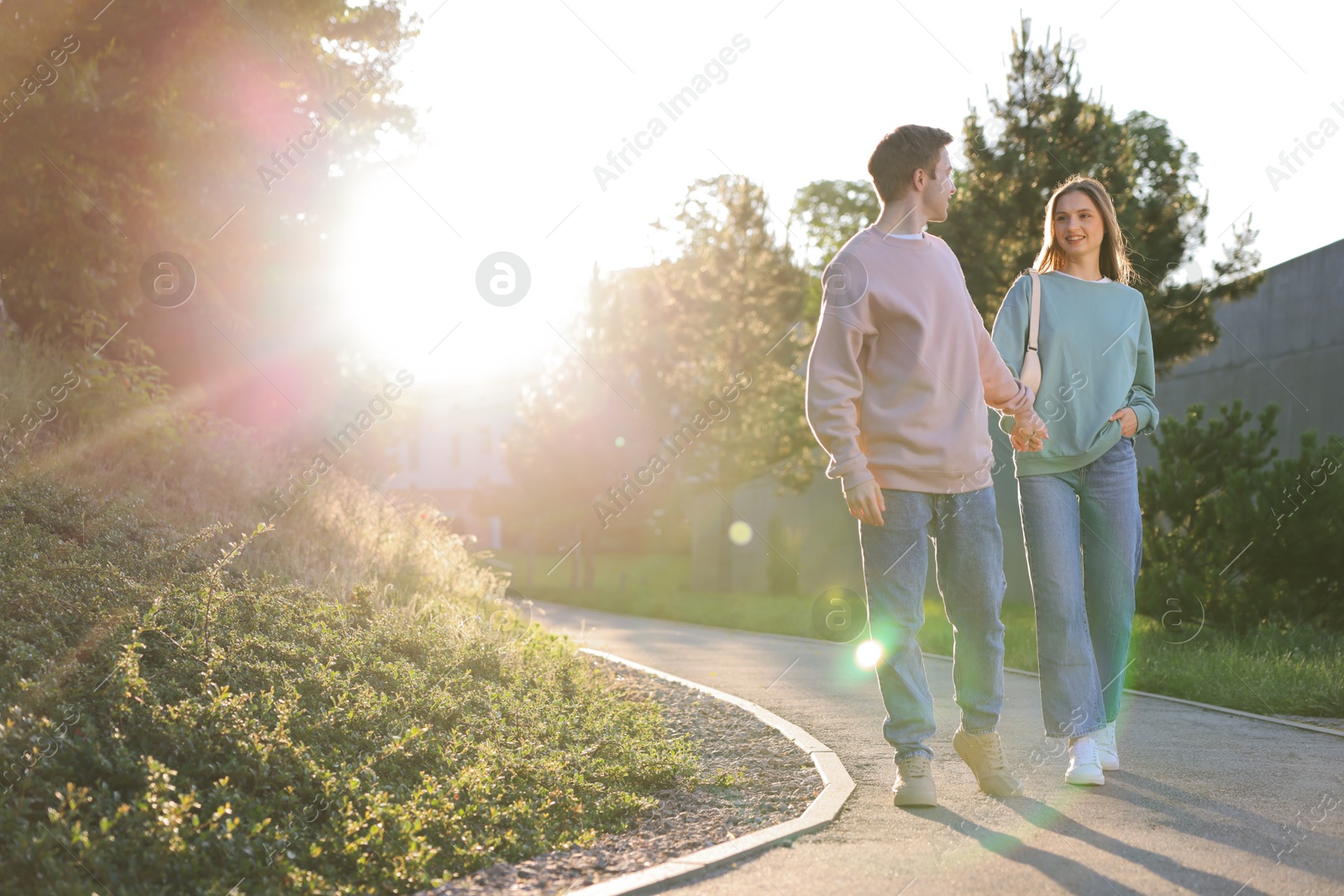 Lovely couple walking together in park, space for text Photo of Lovely couple walking together in park, space for text