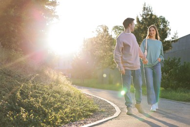 Photo of Lovely couple walking together in park, space for text