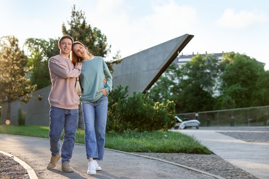 Photo of Lovely couple walking together in park, space for text