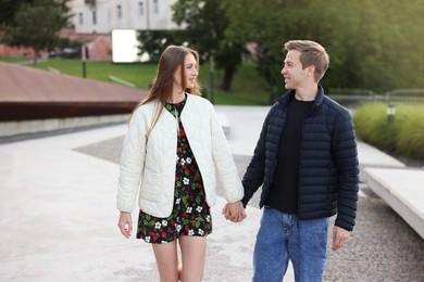 Photo of Lovely couple walking together on city street
