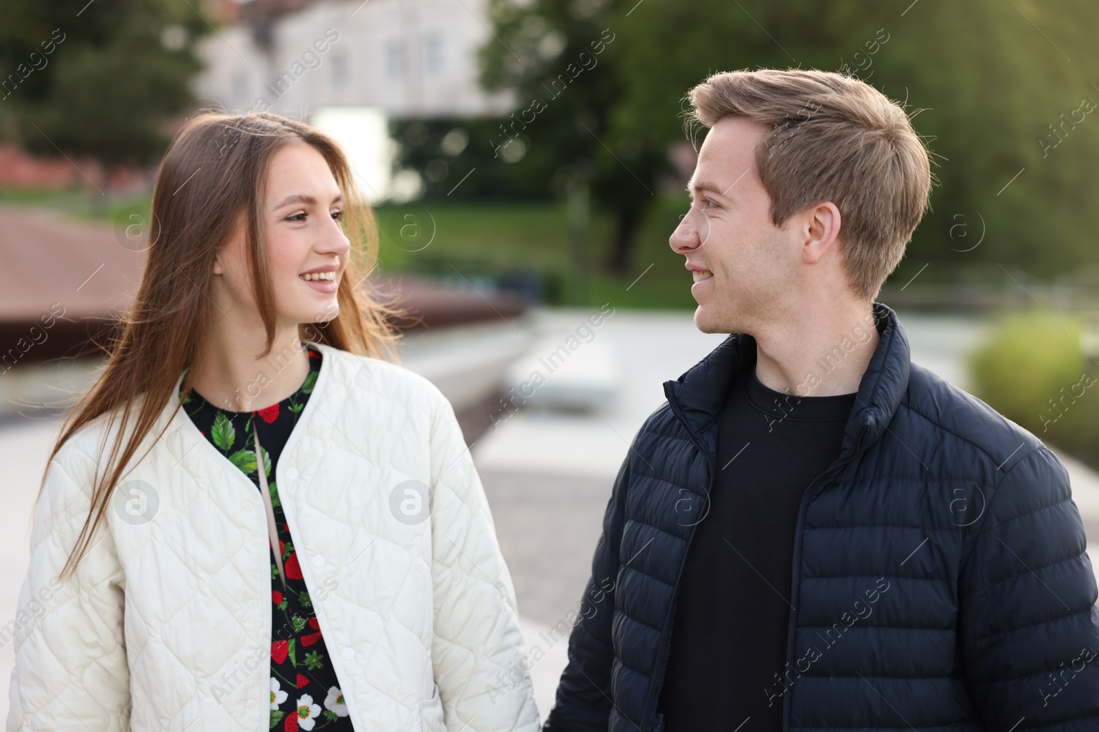 Lovely couple walking together on city street Photo of Lovely couple walking together on city street