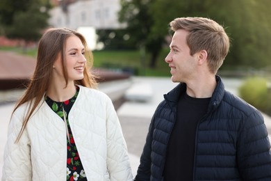 Photo of Lovely couple walking together on city street