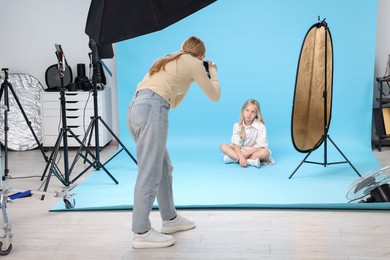 Photo of Photographer working with model in professional photo studio