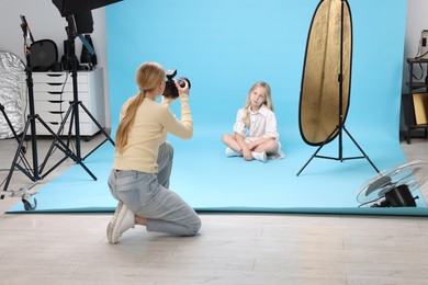 Photo of Photographer working with model in professional photo studio