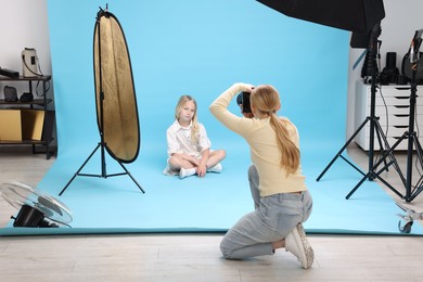 Photo of Photographer working with model in professional photo studio