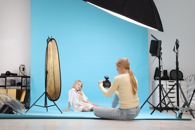 Photo of Photographer working with model in professional photo studio
