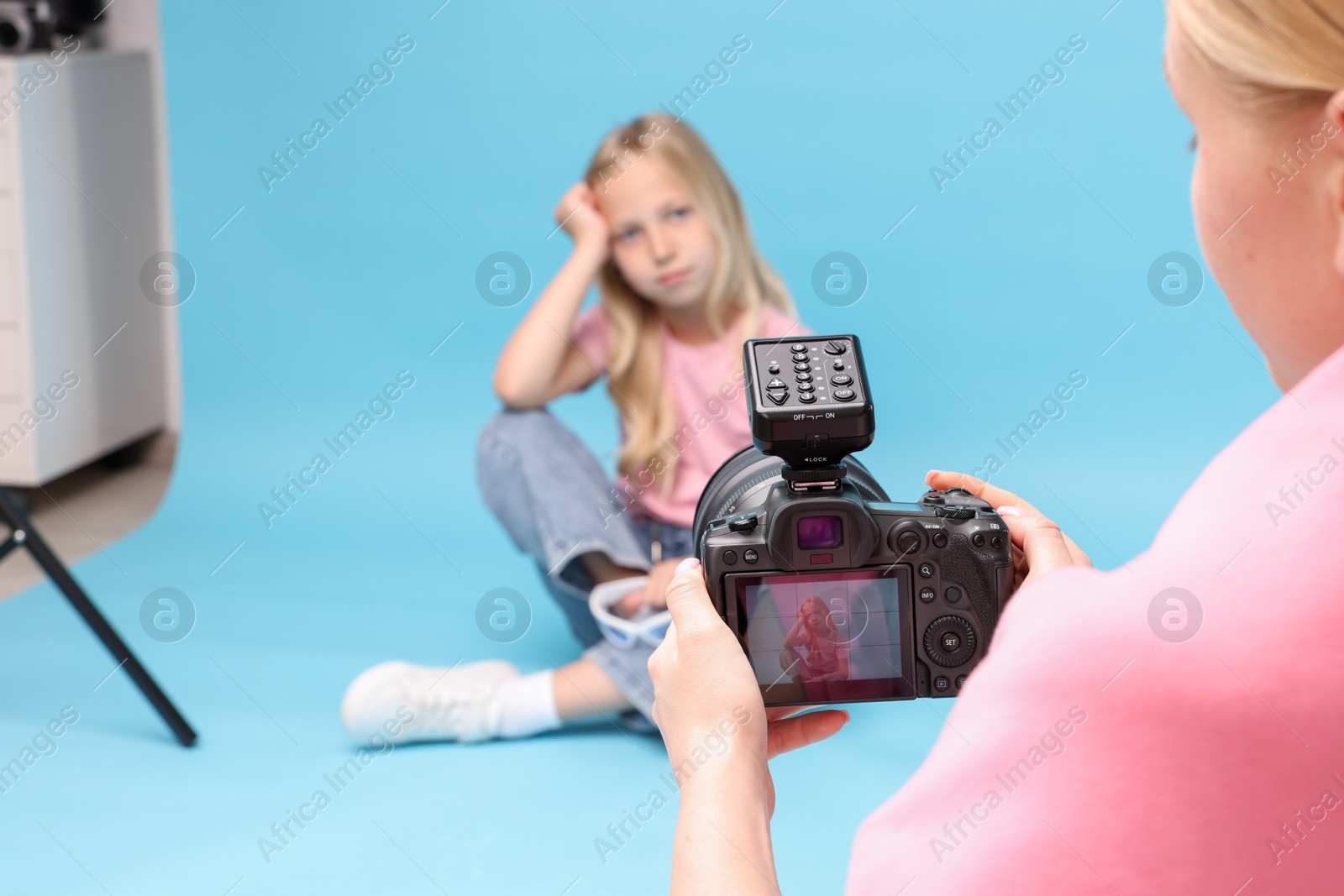 Photographer working with model in professional photo studio, selective focus Photo of Photographer working with model in professional photo studio, selective focus