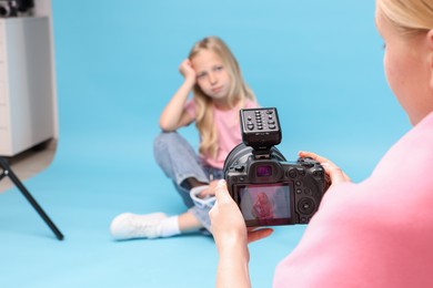 Photo of Photographer working with model in professional photo studio, selective focus