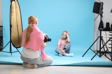 Photo of Photographer working with model in professional photo studio