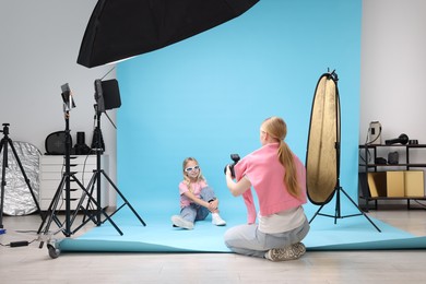 Photo of Photographer working with model in professional photo studio