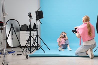 Photo of Photographer working with model in professional photo studio