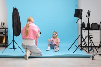 Photo of Photographer working with model in professional photo studio