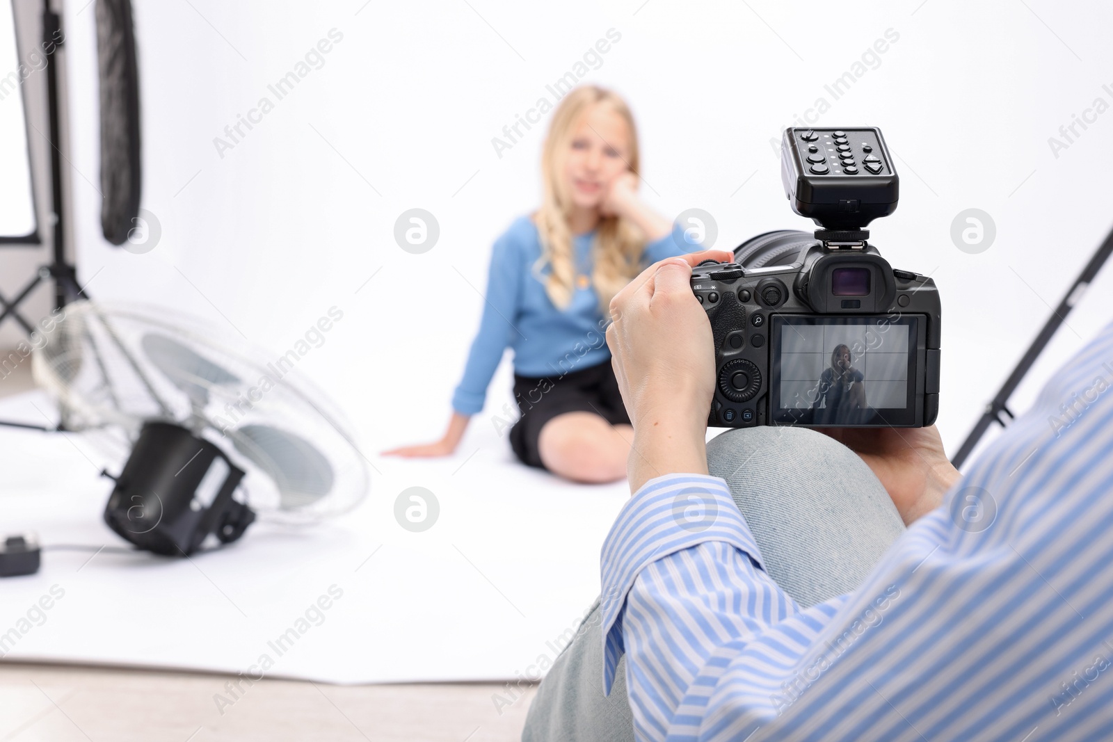 Photographer working with model in professional photo studio, selective focus Photo of Photographer working with model in professional photo studio, selective focus